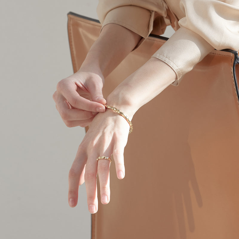 Model wearing Moyoura Natural Wave Gold Bracelet and gold ring