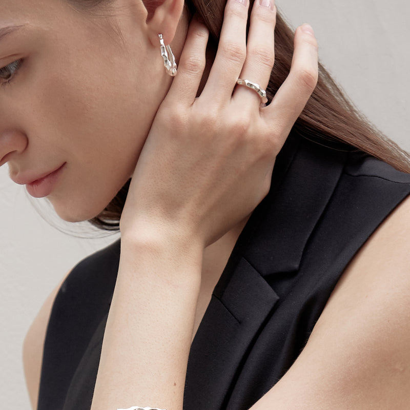 Model wearing Moyoura Natural Wave Silver Ring and Silver Earrings