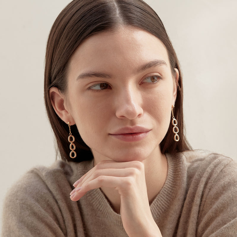 Model wearing Moyoura Connected Ovals Drop Gold Earrings
