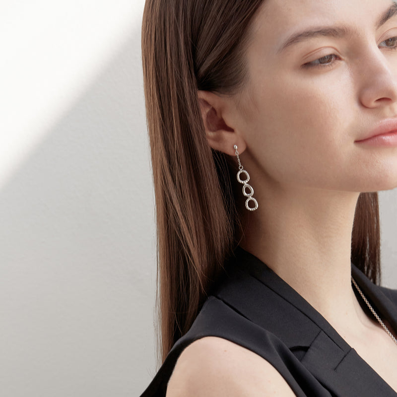 Model wearing Moyoura Connected Ovals Drop Earrings in Silver side view
