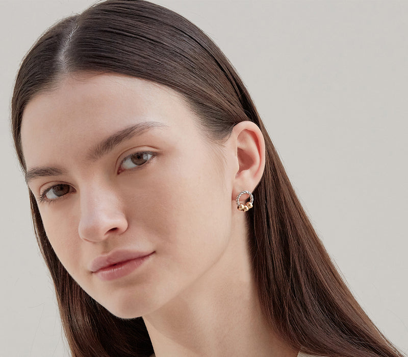 Model wearing Moyoura sterling silver hoop stud earrings with gold beads