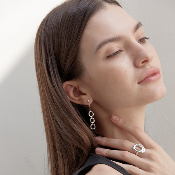 Model wearing Moyoura Key Hole Silver Ring with drop earrings